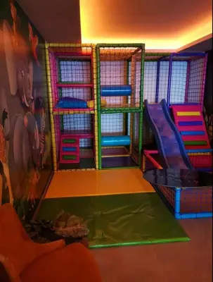 a childrens play area with a slide in a room at Apartman N Lux 100 Milmari resort in Kopaonik
