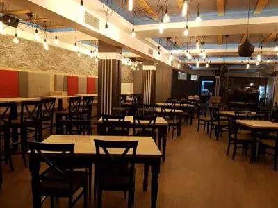 a dining room with tables and chairs and lights at Apartman N Lux 100 Milmari resort in Kopaonik
