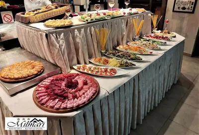a buffet with many plates of food on a table at Apartman N Lux 100 Milmari resort in Kopaonik