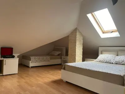 a attic bedroom with two beds and a skylight at Art Studio in Niš