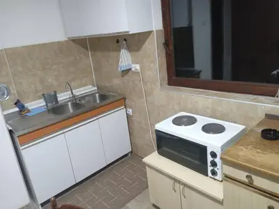 a small kitchen with a sink and a microwave at Apartman MARA in Bor