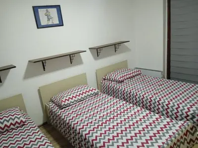 two beds sitting next to each other in a room at Apartman MARA in Bor