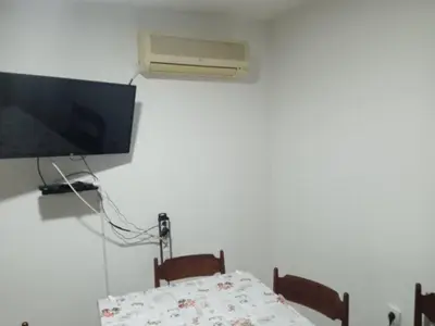 a room with a tv and a bed and a table at Apartman MARA in Bor