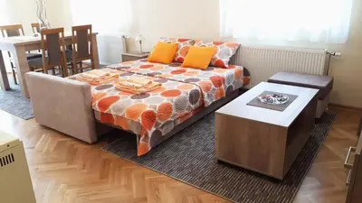 a living room with a couch and a table at Apartman SN in Vrnjačka Banja