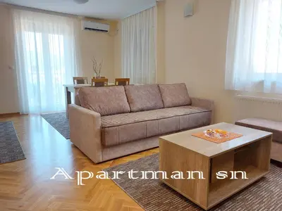 a living room with a couch and a table at Apartman SN in Vrnjačka Banja