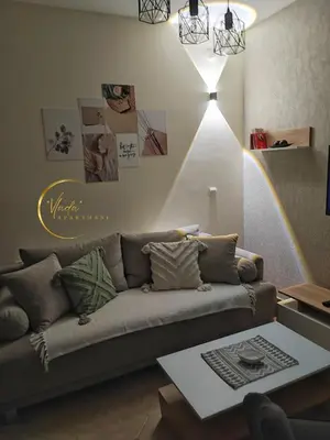 a living room with a couch and a table at Vlada apartmani in Vrnjačka Banja