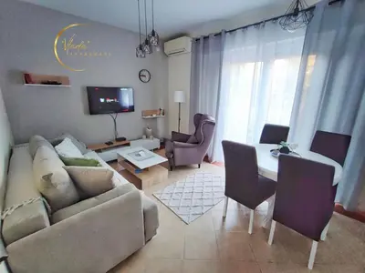 a living room with a couch and a table at Vlada apartmani in Vrnjačka Banja