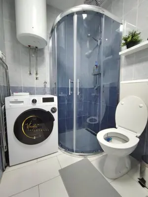 a bathroom with a shower with a toilet and a sink at Vlada apartmani in Vrnjačka Banja