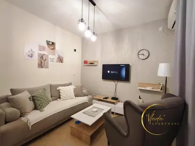 a living room with a couch and a tv at Vlada apartmani in Vrnjačka Banja