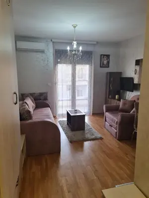 a living room with a couch and a table at Studio Kalina in Vrnjačka Banja