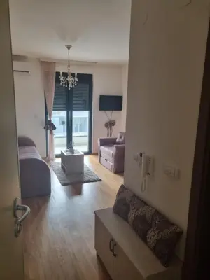 a living room with a couch and a table at Studio Kalina in Vrnjačka Banja