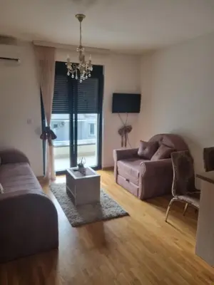 a living room with a couch and a table at Studio Kalina in Vrnjačka Banja