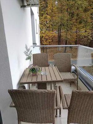 a patio with a table and chairs on a balcony at Studio Kalina in Vrnjačka Banja