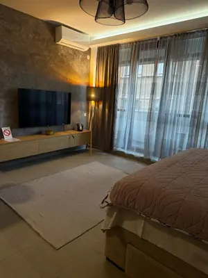 a bedroom with a bed and a flat screen tv at Apartment Niš in Niš