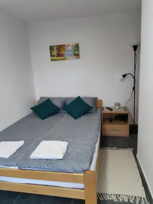 a bedroom with a bed with two towels on it at Vikendica Aki in Zaječar