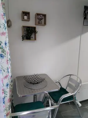 a table and two chairs in a room at Vikendica Aki in Zaječar