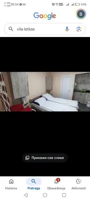 a picture of a room with a bed and homepage at Vikendica Aki in Zaječar
