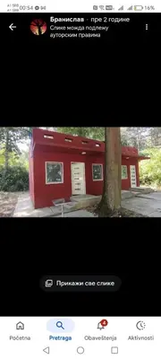 a picture of a red building with a tree at Vikendica Aki in Zaječar