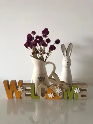 two vases and a rabbit on a shelf with flowers at Tesla 30 in Kruševac