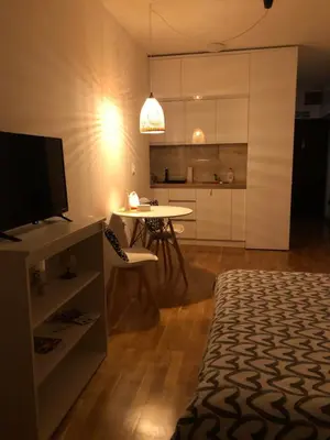 a living room with a television and a dining room table at Tesla 30 in Kruševac