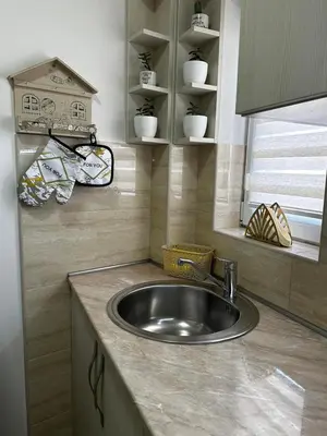 a kitchen counter with a sink and a window at L&D apartman in Kruševac