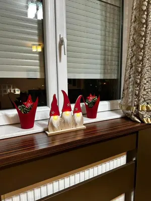 four figurines of birds are sitting on a window sill at L&D apartman in Kruševac