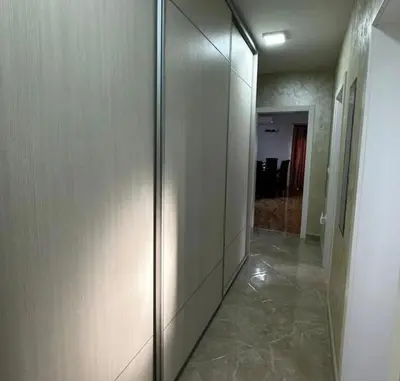a hallway with a glass elevator in a building at L&D apartman in Kruševac