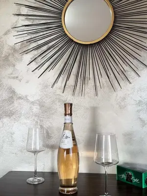 a bottle of wine and two wine glasses on a table at L&D apartman in Kruševac