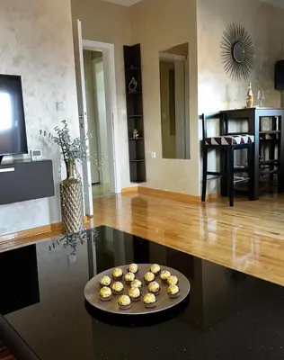 a tray of cupcakes on a table in a living room at L&D apartman in Kruševac