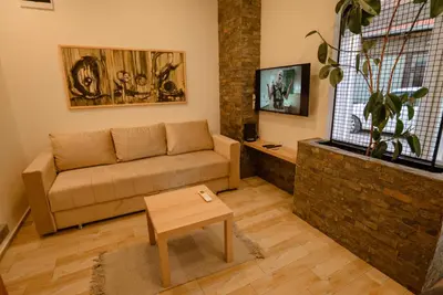 a living room with a couch and a table at Sen's Studio in Leskovac