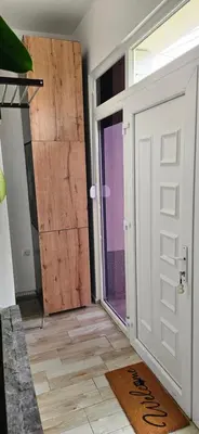 an open door in a room with a wooden door at Sen's Studio in Leskovac