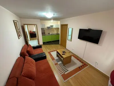 a living room with a couch and a flat screen tv at Apartmani Ušće in Trstenik