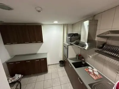 a kitchen with a sink and a stove top oven at Apartmani Ušće in Trstenik