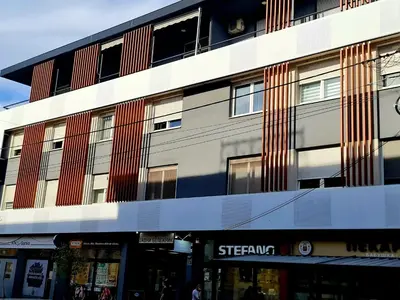 a building on a street in front of a store at Babuska studio in Jagodina