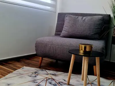 a living room with a couch and a table at Babuska studio in Jagodina