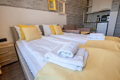 a large white bed with towels on top of it at Alethea Lux Apartments, Milmari Resort Kopaonik in Kopaonik