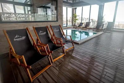 a group of chairs in a lobby with a pool at Alethea Lux Apartments, Milmari Resort Kopaonik in Kopaonik