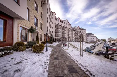 a snow covered sidewalk in front of a building at Alethea Lux Apartments, Milmari Resort Kopaonik in Kopaonik