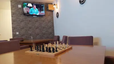 a chess board on a table in a room at Apartments Tatic in Kopaonik