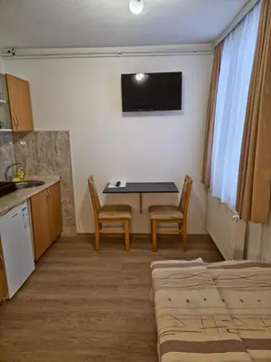 a kitchen with a table and two chairs in a room at Apartments Tatic in Kopaonik