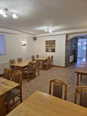 a dining room with wooden tables and chairs at Apartments Tatic in Kopaonik