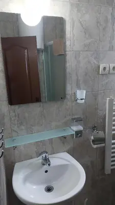 a bathroom with a sink and a mirror at Apartments Tatic in Kopaonik
