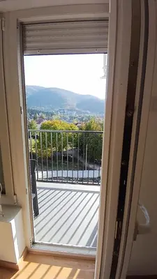 a sliding glass door with a view of a balcony at Dva brata in Soko Banja
