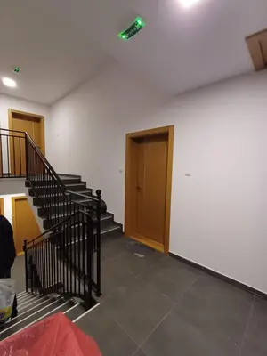 an empty room with stairs and a green light on the ceiling at Dva brata in Soko Banja