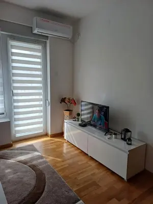 a living room with a flat screen tv on a table at Dva brata in Soko Banja