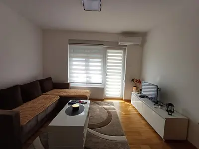 a living room with a couch and a tv at Dva brata in Soko Banja