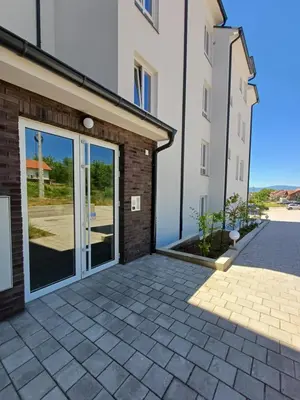 a patio in front of a building with sliding glass doors at Dva brata in Soko Banja