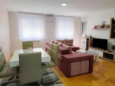 a living room with a couch and a table at Apartman LARA in Pirot