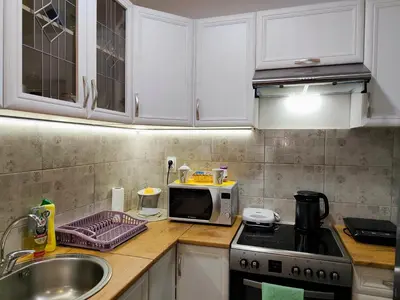 a kitchen counter with a microwave and a sink at Apartman LARA in Pirot