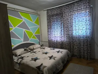 a bedroom with a bed and a window at Jednosoban stan centar Ela, in Pirot